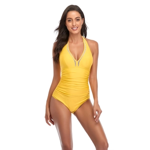 Detail of yellow one-piece swimsuit featuring V-neckline with striped trim and ruched waist