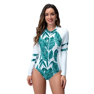 Close-up of tropical leaf prints and white front zipper on long sleeve surfing swimsuit