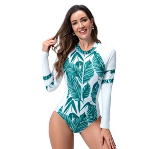 Front view of women's long sleeve swimsuit with tropical green leaf print and front zipper