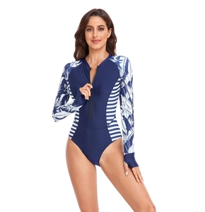 Detail of long sleeve swimsuit featuring tropical leaf print and side stripe accents