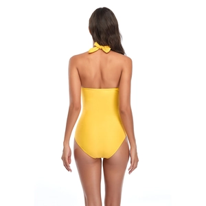 Rear view of vibrant yellow one-piece halter swimsuit with backless cut and bow tie