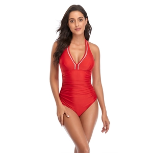 Detail of red V-neck one-piece swimsuit featuring elegant striped trim and ruched waist