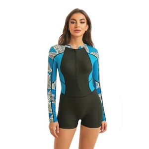 Detail of long sleeve swimsuit with front zipper and tropical palm leaf print