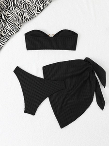 Three-piece black ribbed bikini set with bandeau top, briefs, and matching tie-up beach skirt