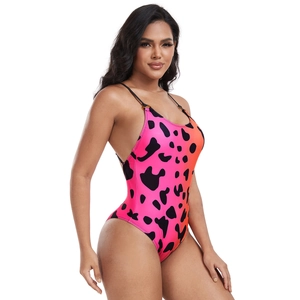 Detail of pink and orange gradient swimsuit with black cow print and decorative rings