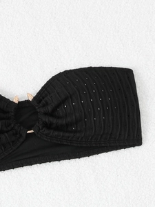 Close-up of black mesh bikini top with textured ribbing and gold metal ring detail