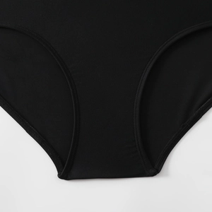 Close-up of flatlock stitching and premium elastic knit fabric on black surf swimsuit