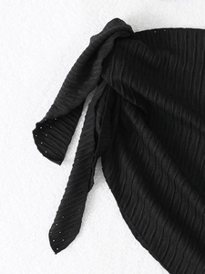 Detail of black eyelet mesh fabric with ripple texture and side tie knot for bikini skirt