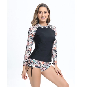Close-up of floral print long sleeves and drawstring shorts on a two-piece surf swimsuit