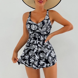 Detail of high-waisted floral swim dress with tropical leaf print and V-neckline straps