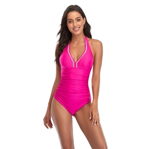 Detail of hot pink ruched one-piece swimsuit with V-neckline and halter neck design