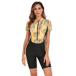 Detail of front zipper and tropical floral print on black one-piece short sleeve surfing swimsuit