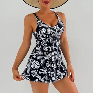 Detail of V-neck swim dress featuring black and white tropical palm leaf floral print