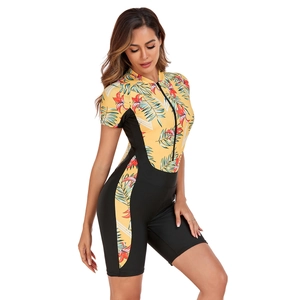 Detail of floral surf swimsuit featuring a front zipper and sporty short sleeves