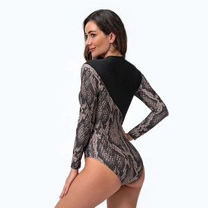 Detail of long sleeve swimsuit featuring grey snakeskin print and black matte stitching