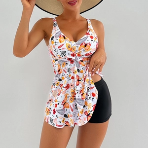 Detail of floral printed swim dress top with knot design and black swim shorts