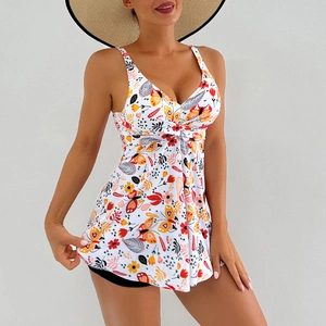 Detail of floral print swim dress with V-neck twist knot and matching black shorts