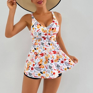 Detail of high-waist swim skirt with colorful floral print and twist-knot design