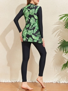 Detail of long sleeve rash guard with tropical leaf print and black leggings