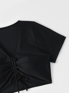 Detail of black V-neck swimsuit top with stylish ruched drawstring and elastic texture