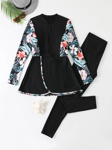 Flat lay of modest two-piece floral long sleeve swimwear with beach vacation accessories