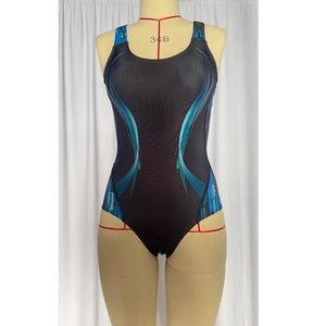 Detail view of athletic one-piece swimsuit with blue geometric prints and crossback straps