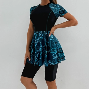 Detail of short sleeve modest surf suit with blue floral print and swim leggings