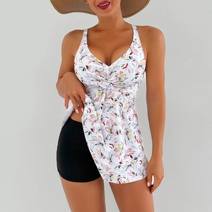 Detail of high-waist floral print swim dress with crossover V-neck and black boy shorts