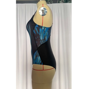 Close-up of women's one-piece swimsuit featuring colorful side panels and artistic patterns