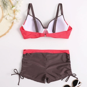 Flat lay of a two-piece bikini with color-blocking top and drawstring swim shorts