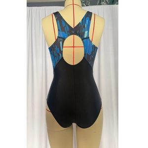 Racerback detail of one-piece competitive swimsuit with geometric print and cutout