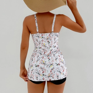 Back view of printed floral tankini top with thin straps and black swim shorts for women
