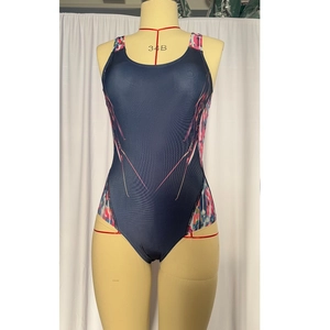 Detail of blue competitive swimsuit with floral splicing on side of the athletic fabric