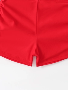 Detailed view of red high-elastic swim shorts with double-needle stitching and smooth hem