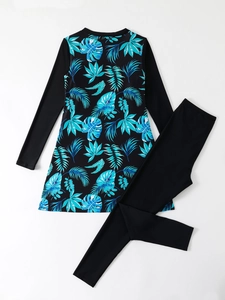 Detail showing tropical leaf print on modest long sleeve two-piece swimsuit and leggings