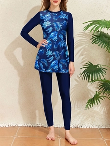 Detail of long-sleeve swimwear featuring tropical leaf prints and high-stretch fabric
