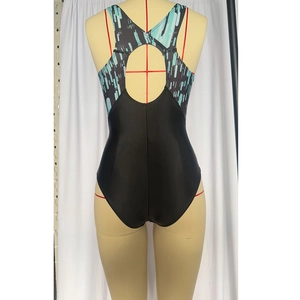Detail of racerback one-piece swimsuit featuring back cutout and geometric print