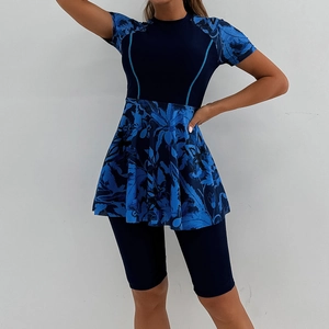 Women's two-piece short sleeve surfing swimsuit with tropical leaf print and modest skirt
