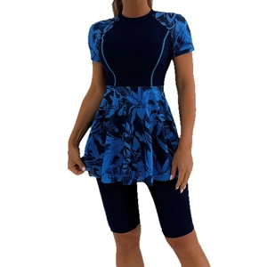 Women's two-piece modest floral surf suit with short sleeve top and shorts