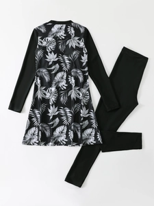 Detailed flat lay of women's long sleeve modest swimwear with tropical leaf print