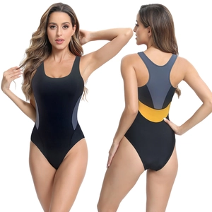 Detail showing the gray and yellow geometric side patchwork on a black athletic swimsuit