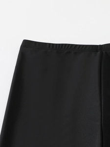 Close-up of wide elastic waistband on high-stretch black long-sleeved swimwear leggings