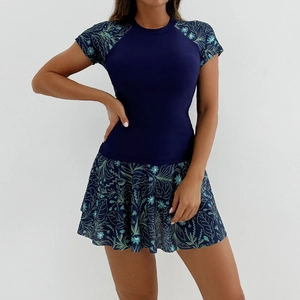 Detail of navy blue short-sleeve swim top and floral skirt with breathable fabric