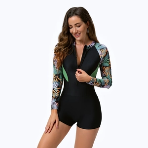 Women's long sleeve one piece swimsuit with tropical leaf print and front zipper closure