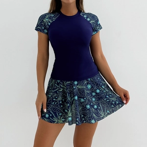 Detail of short sleeve swim top and floral skirt with dark blue raglan sleeves