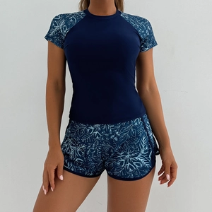 Detail of navy blue two-piece tankini with floral print short sleeves and elastic shorts