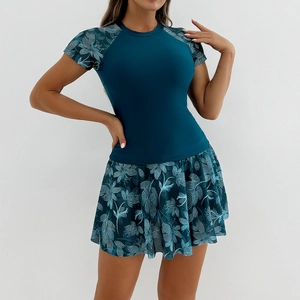 Detailed view of women's two-piece swimsuit with floral sleeves and pleated skirt