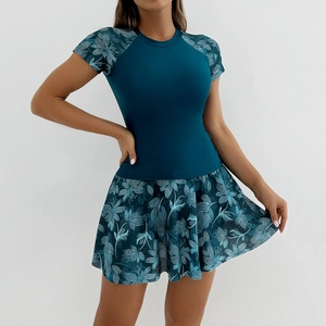 Detail of teal short-sleeved top with floral print raglan sleeves and matching pleated swim skirt