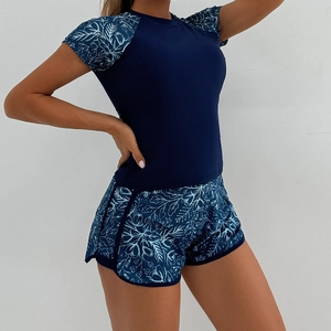 Detail of short sleeve tankini set with floral print sleeves and matching boyleg shorts