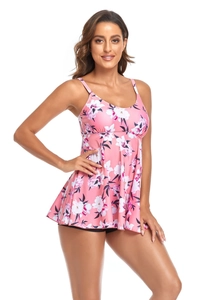 Detail view of pink floral tankini top with spaghetti straps and black swim shorts